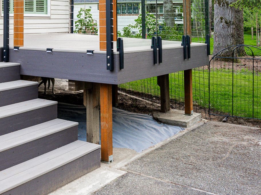 Elevated porch deck with stairs and garden view.