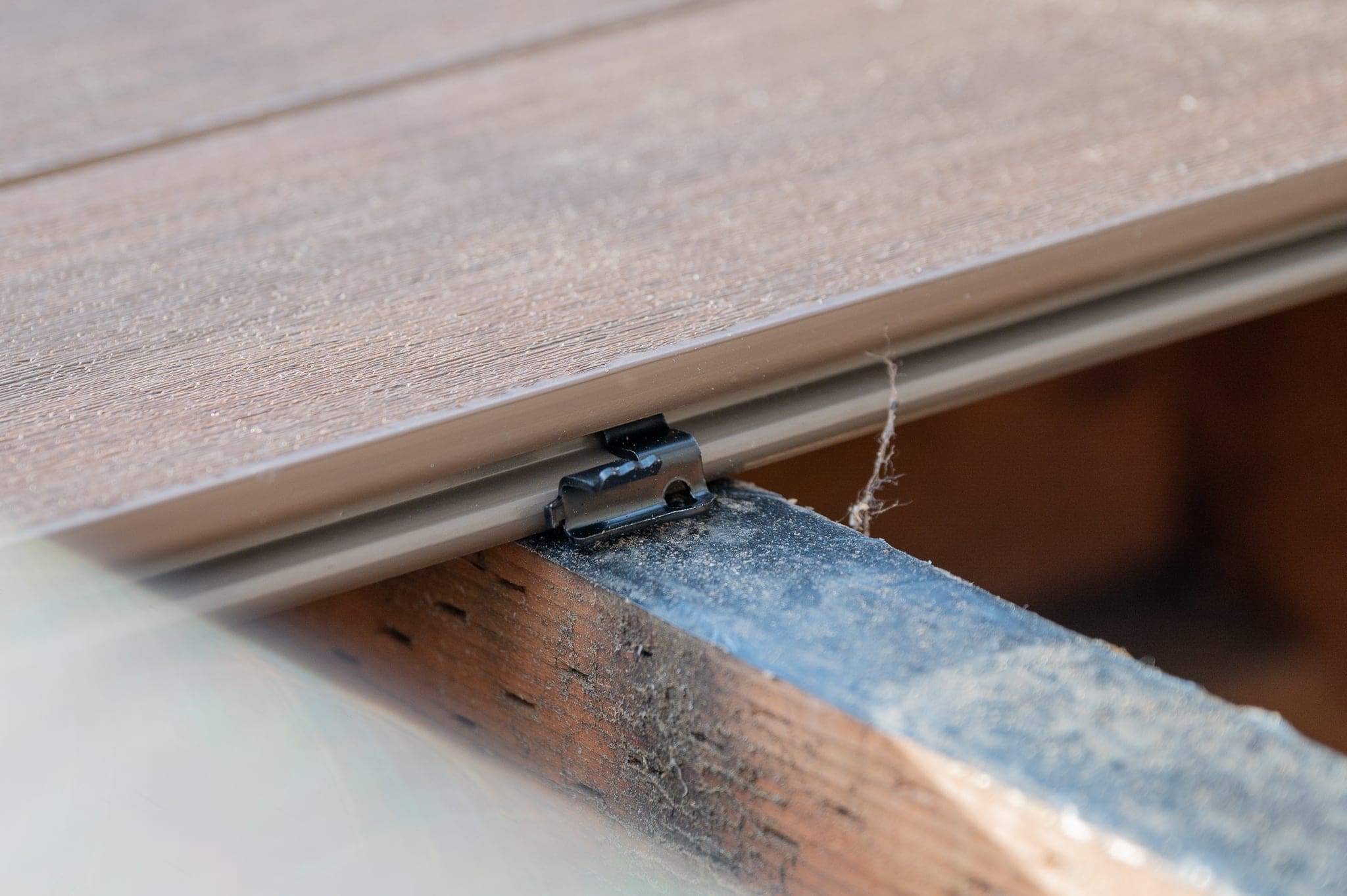 Close-up of decking board clip installation