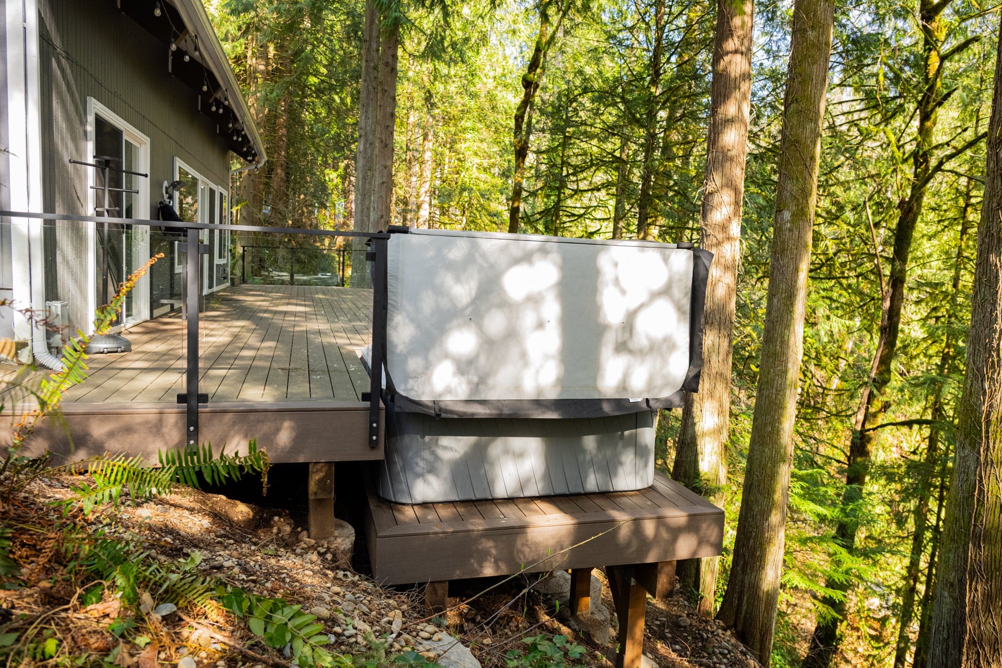 Forest cabin deck with outdoor hot tub