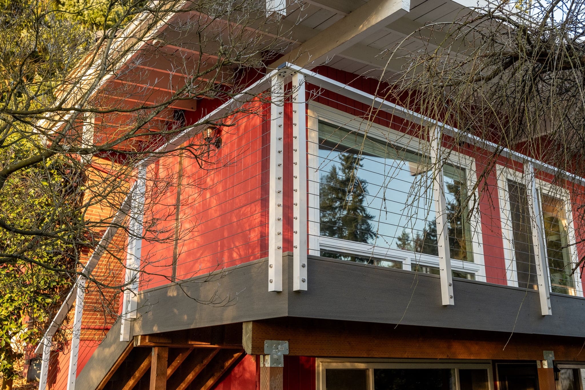 Red house corner with modern balcony and windows