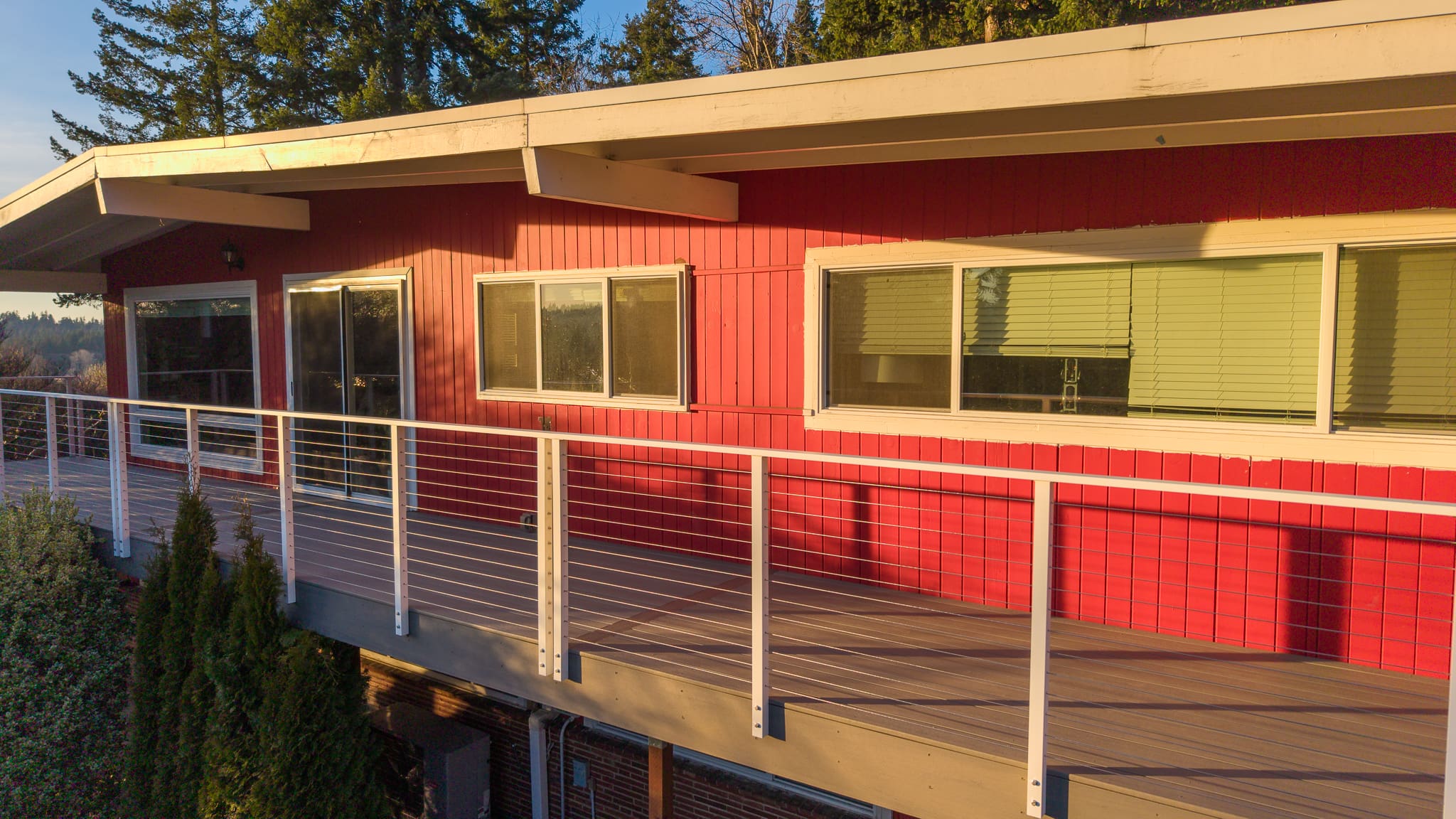 Red mid-century modern house with balcony railing