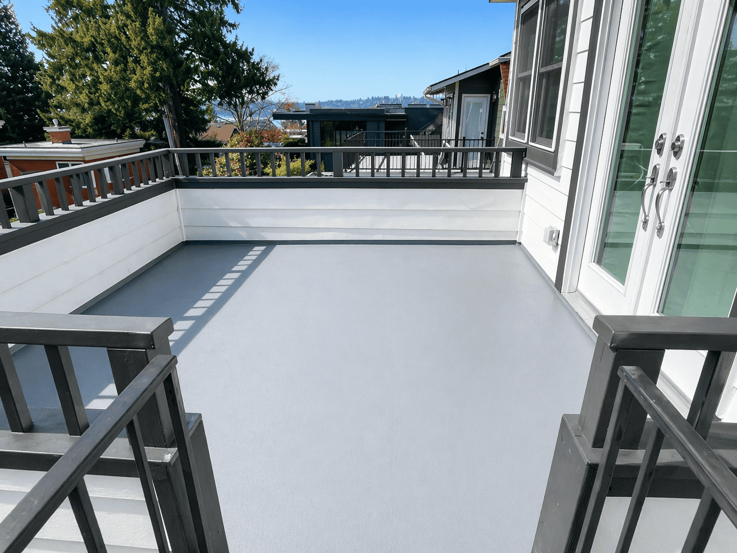 Modern gray balcony with black railings and view