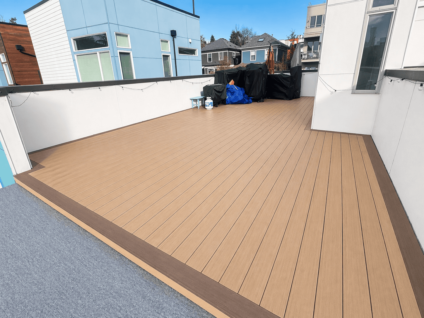 Spacious modern rooftop deck with wooden flooring