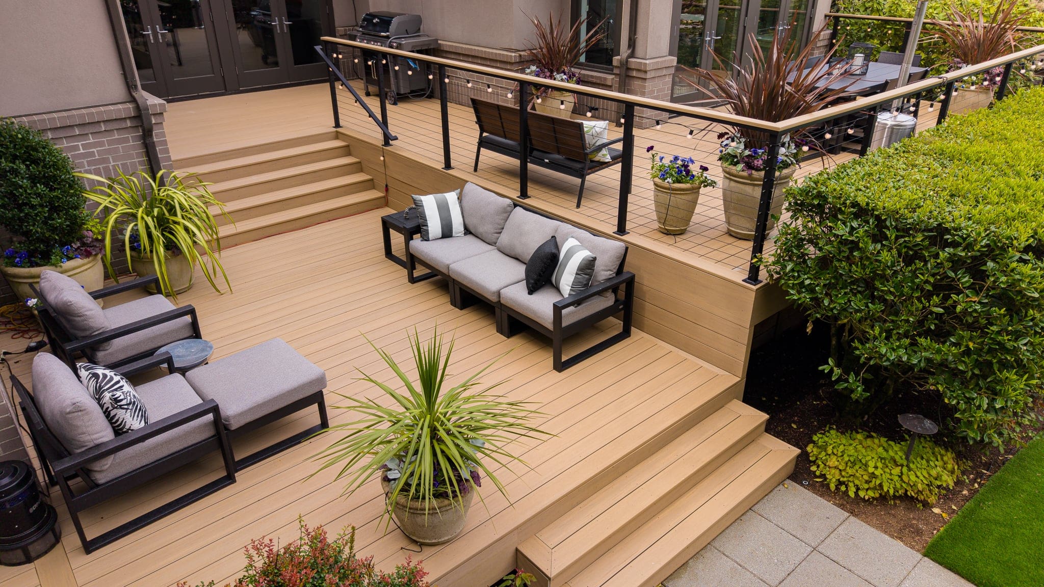 Multi-level wooden deck with modern outdoor seating