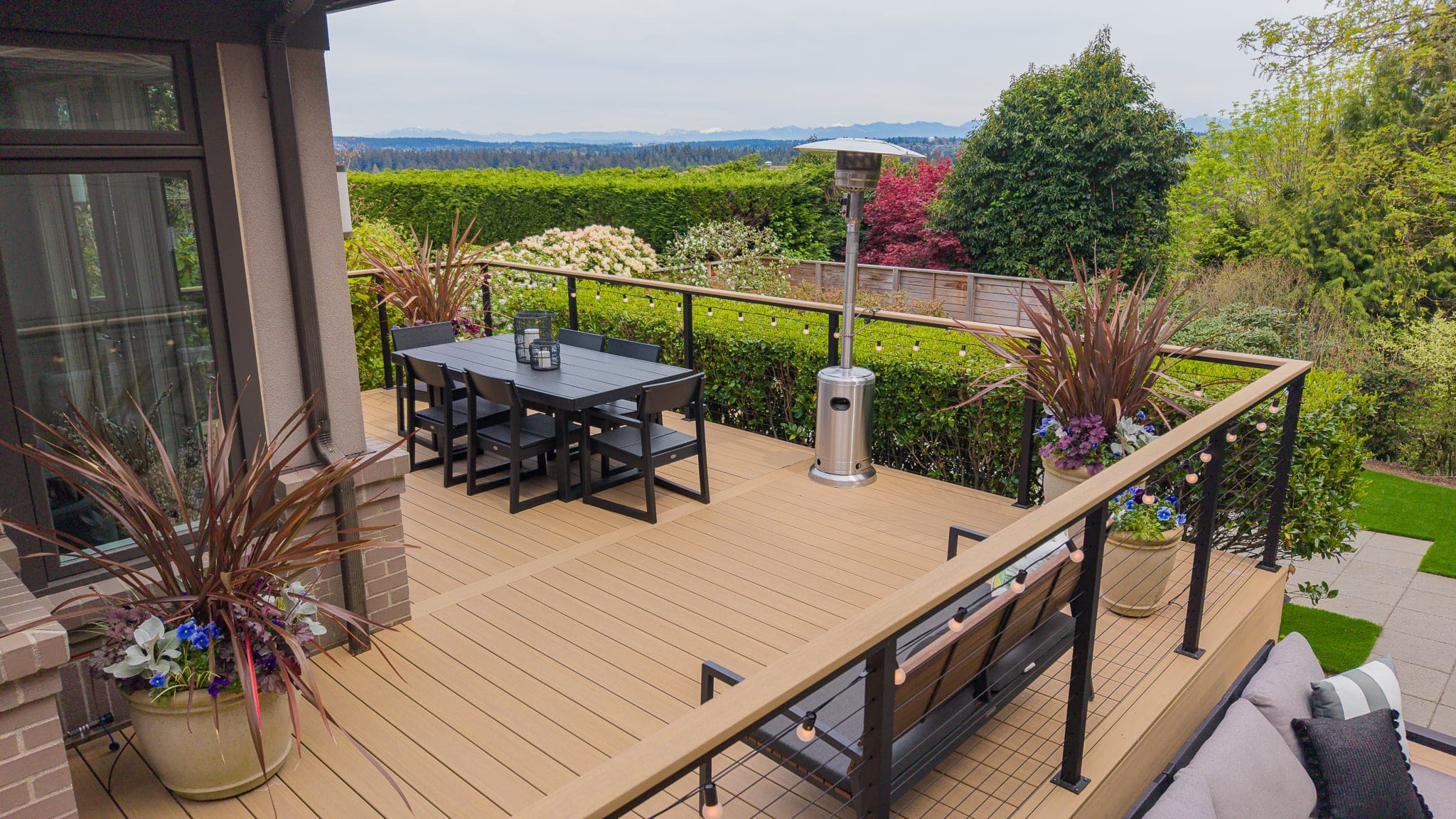 Modern outdoor deck with dining set and heater