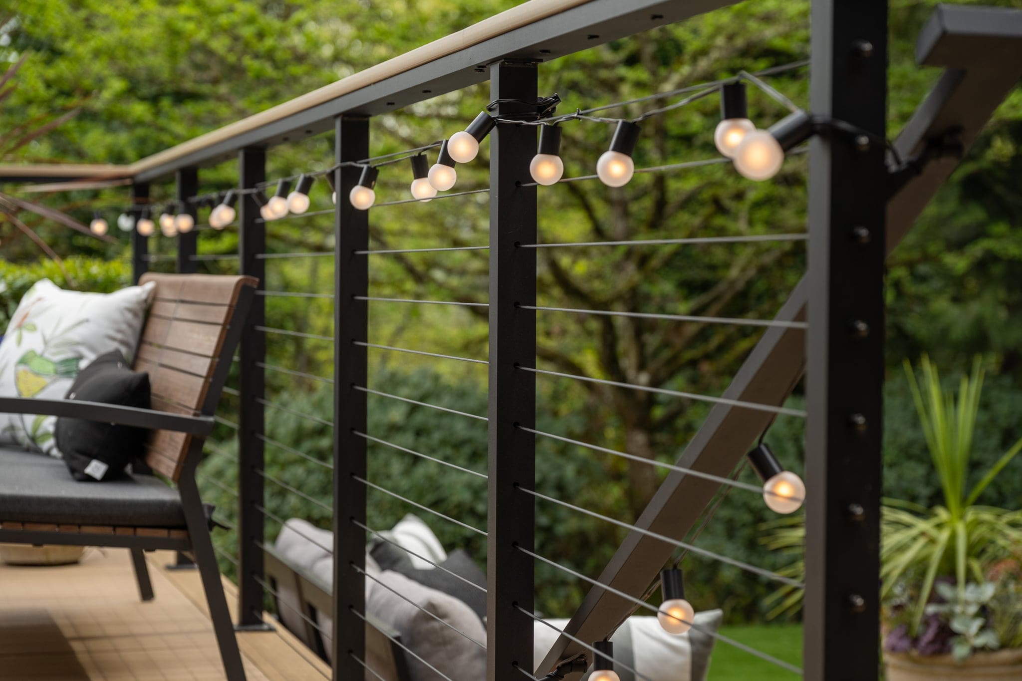 Outdoor deck railing with glowing string lights