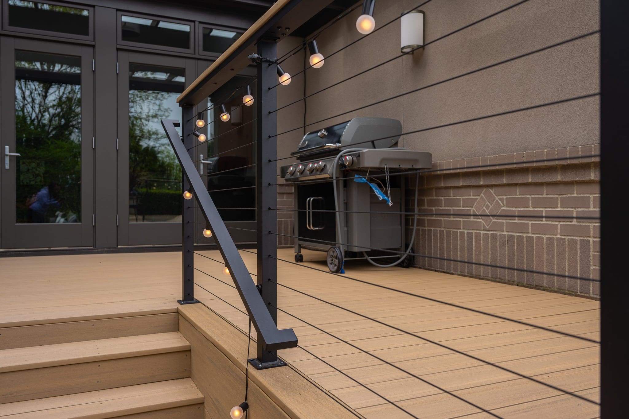 Modern deck with grill and string lights