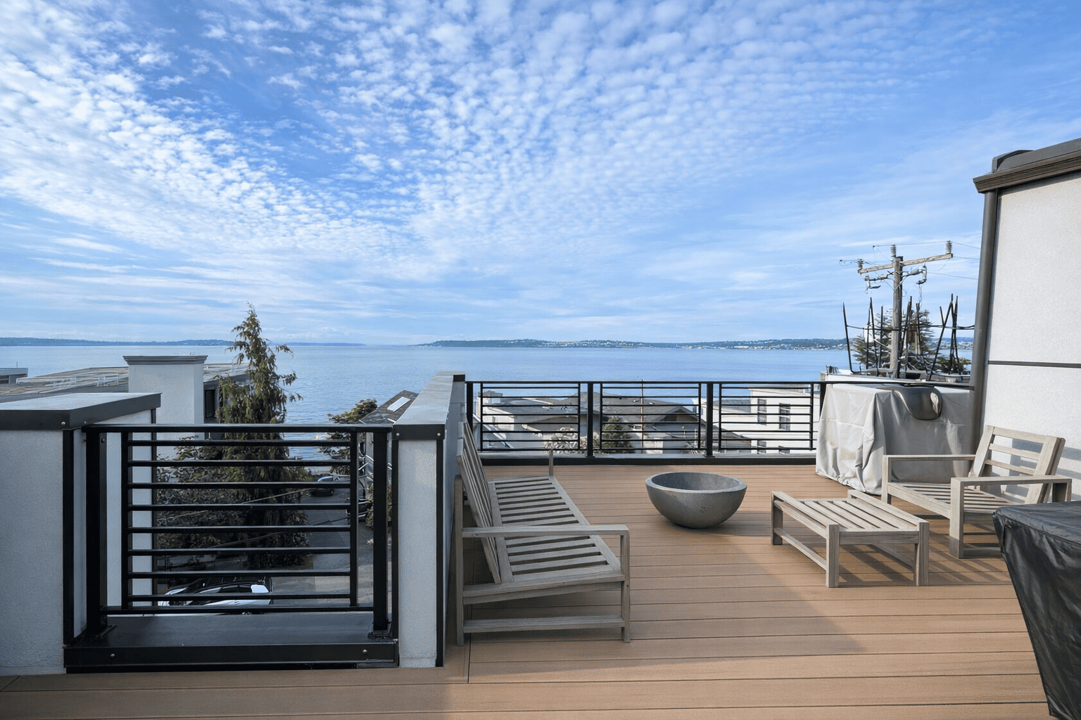 Rooftop deck with chairs overlooking calm waterfront puget sound