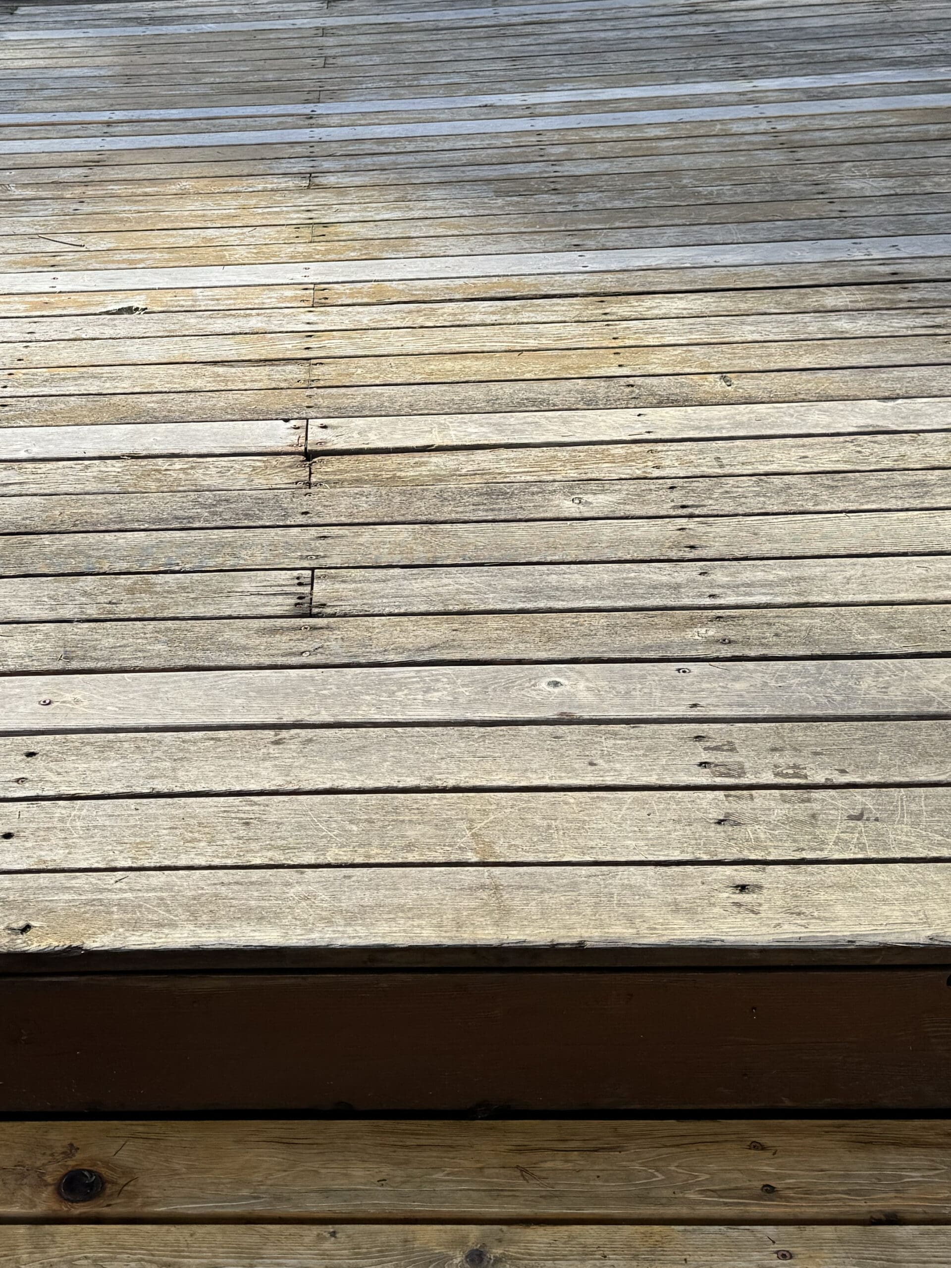 Weathered wooden deck boards in sunlight